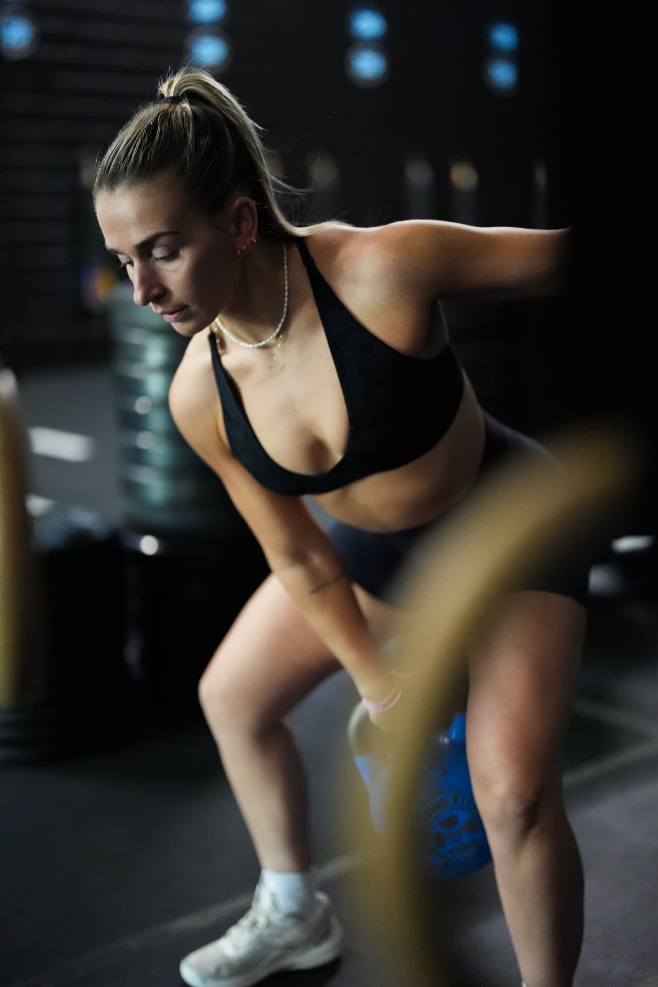 Athlete swinging a kettlebell during a coached training session at Arsenal Health