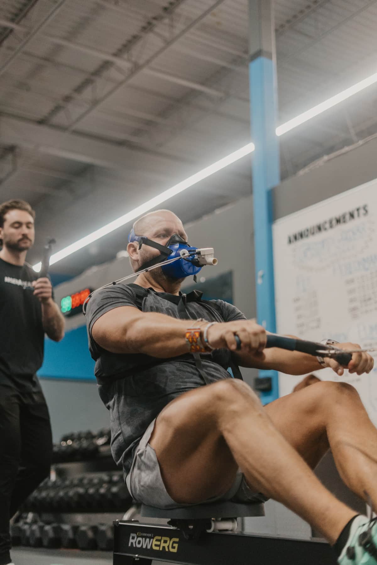 HYROX training athletes in Arsenal Health facility with rowing machines and sleds