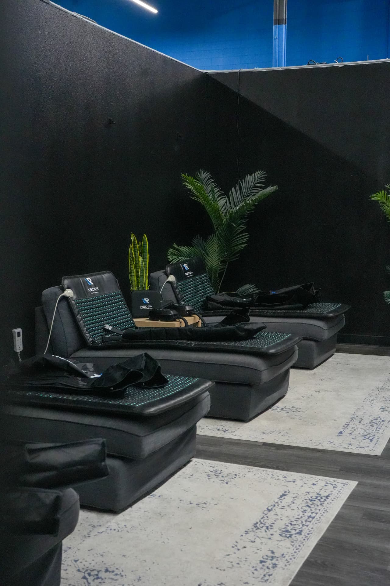 Recovery lounge at Arsenal Health with heated massage chairs and compression boots