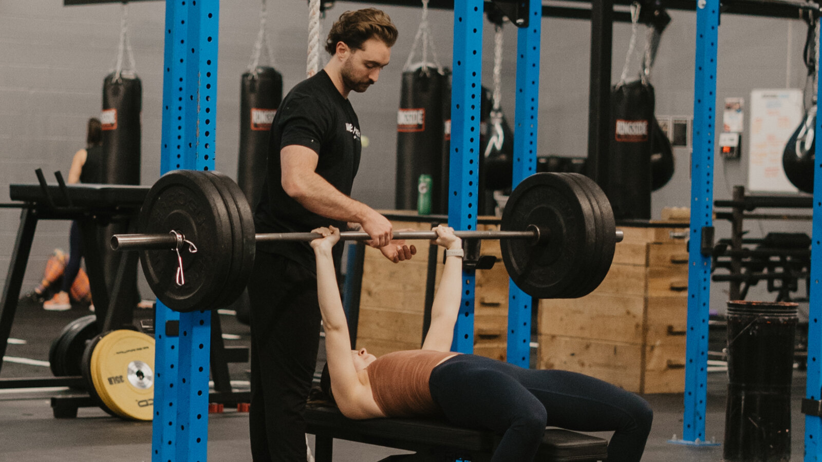 Personal trainer working with a client on back pain recovery at Arsenal Health Denver