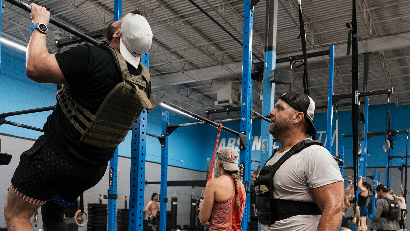 Personal trainer working with a client on shoulder pain recovery at Arsenal Health Denver